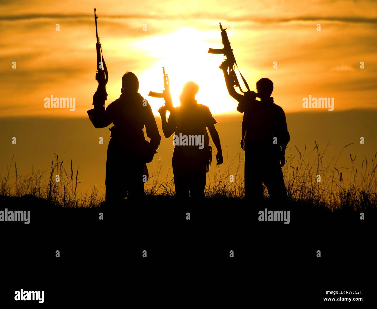 Soldiers against a sunset. Stock Photo