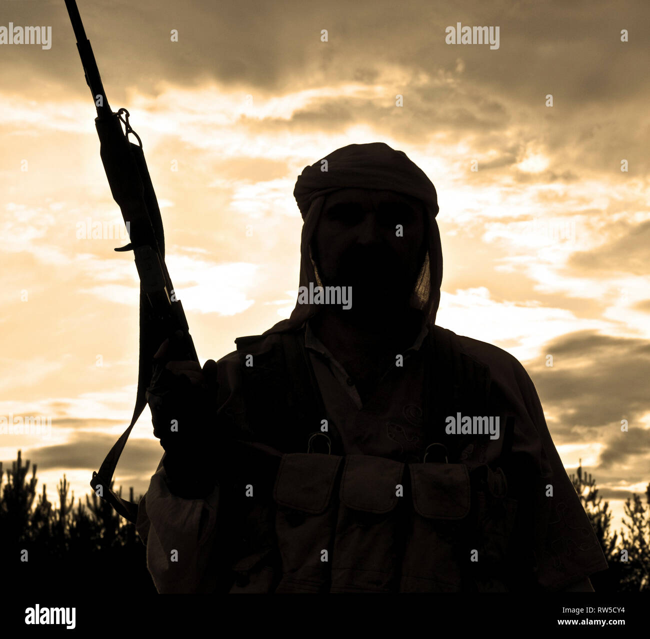 Silhouette of muslim rebel with rifle Stock Photo - Alamy