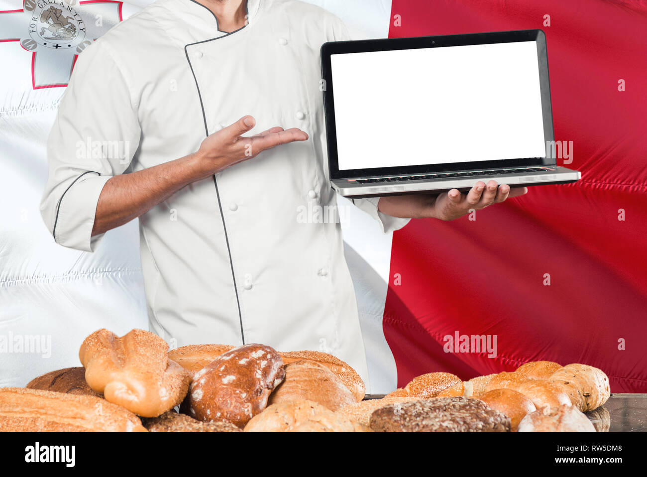 Maltese Baker holding laptop on Malta flag and breads background. Chef
