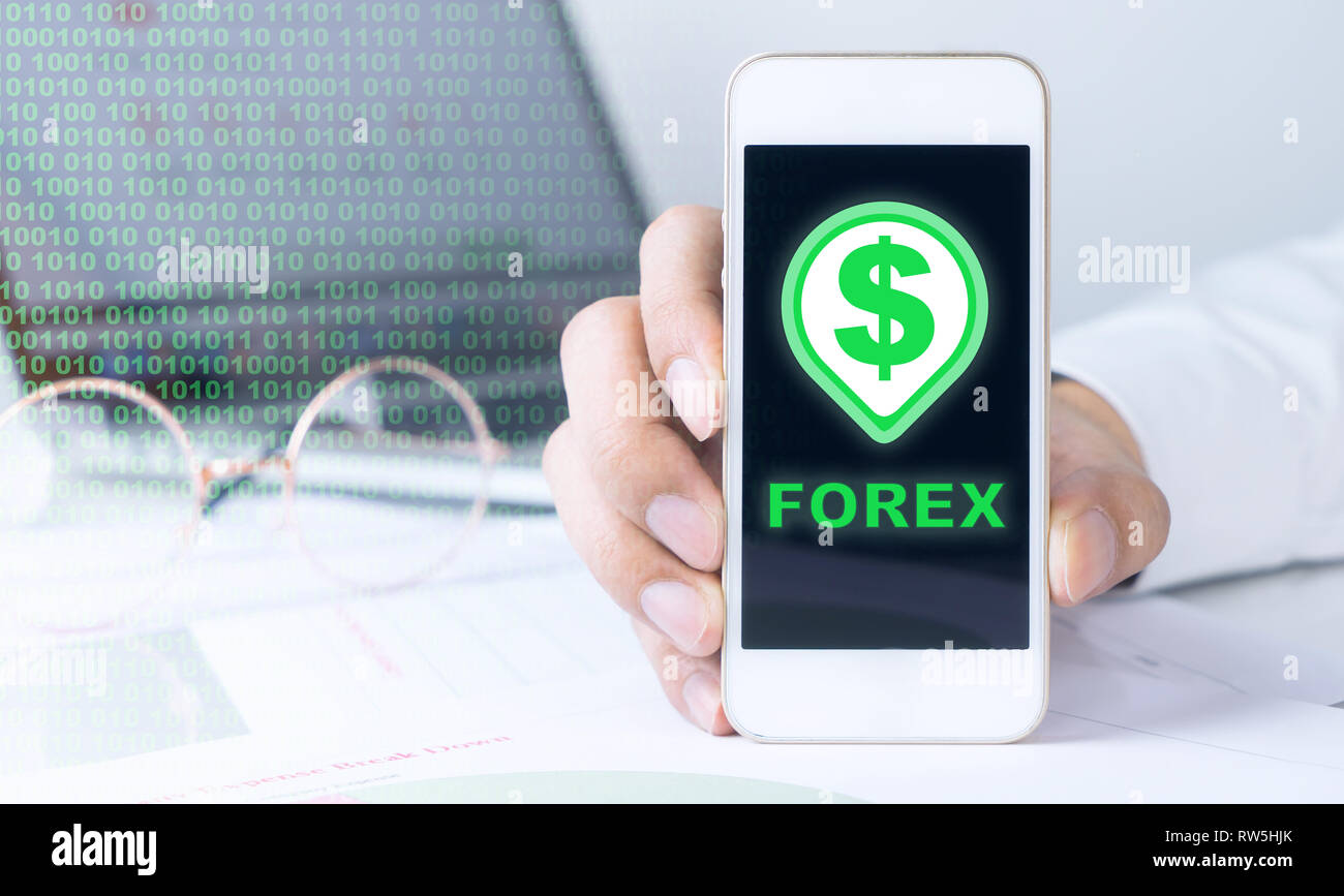 Business Man Is Holding A Phone For Forex Trading Stock Photo - 
