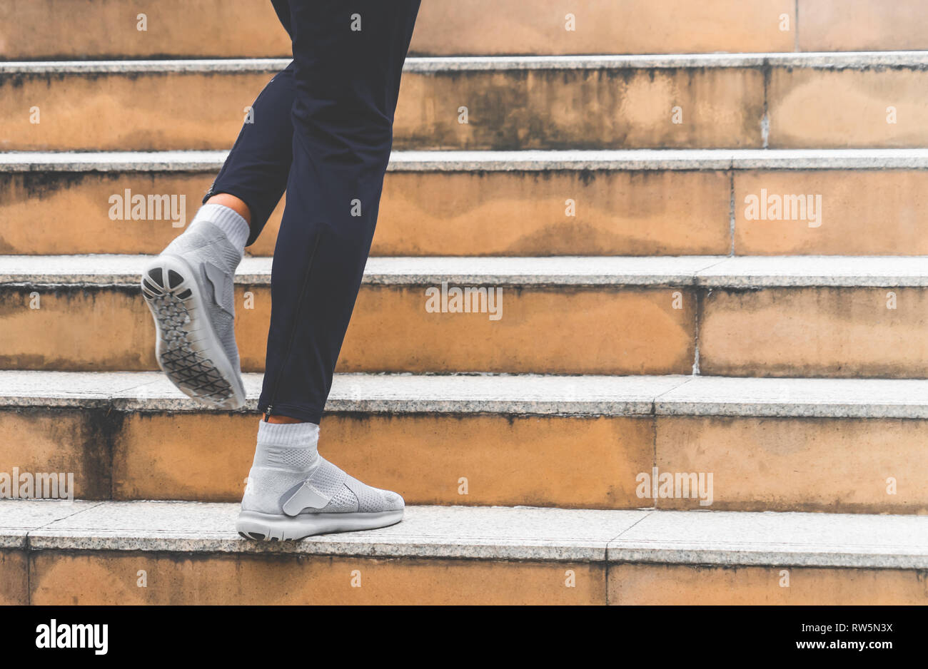 Black man running up stairs hi-res stock photography and images - Alamy