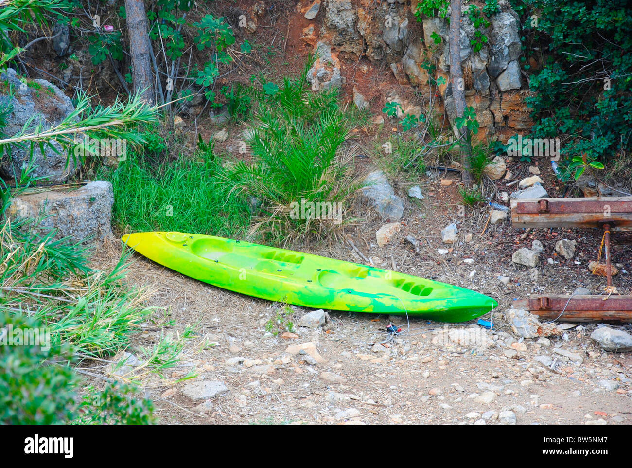 single surf board laying in the palmbay of Sisi, Crete, Greece Stock