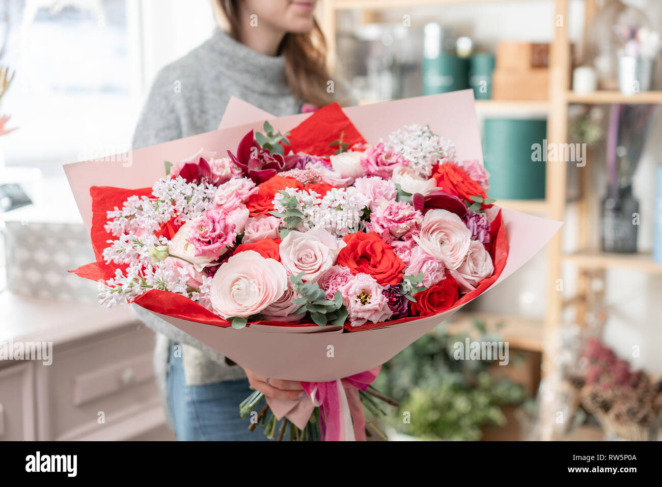 beautiful fresh cut bouquet of mixed flowers in woman hand. the work of