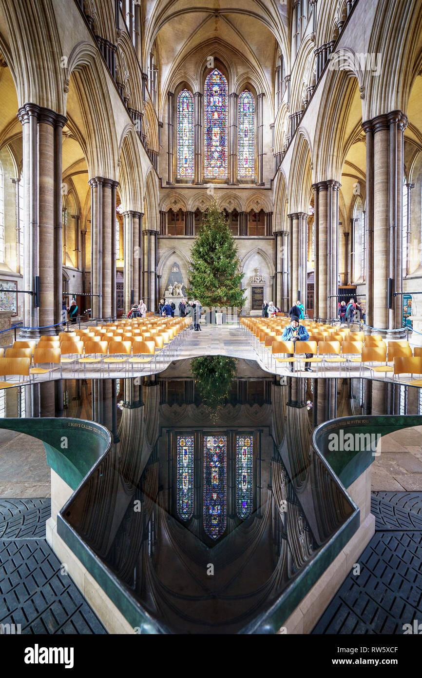 Christmas tree and stained glass window reflected in Salisbury Cathedral font Stock Photo