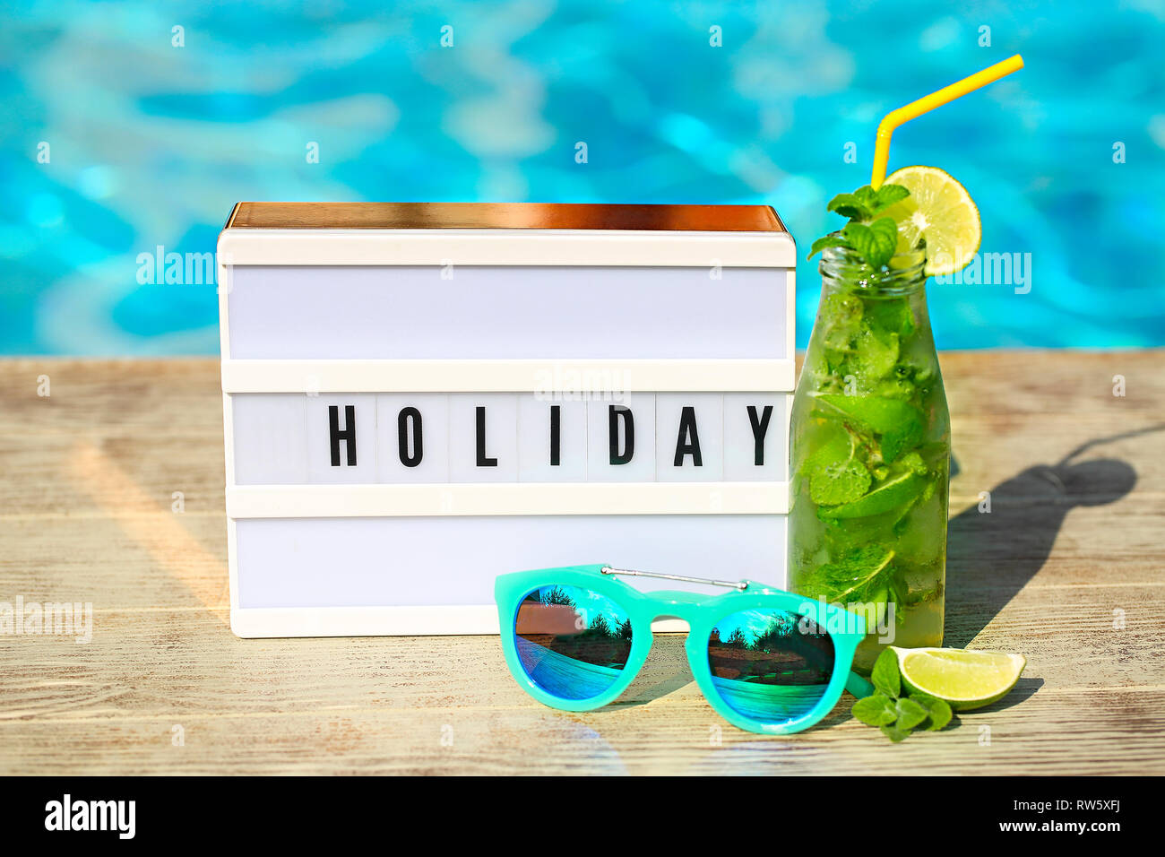 Light letterbox with word Holiday, hat, sunglasses and Mojito cocktail ...