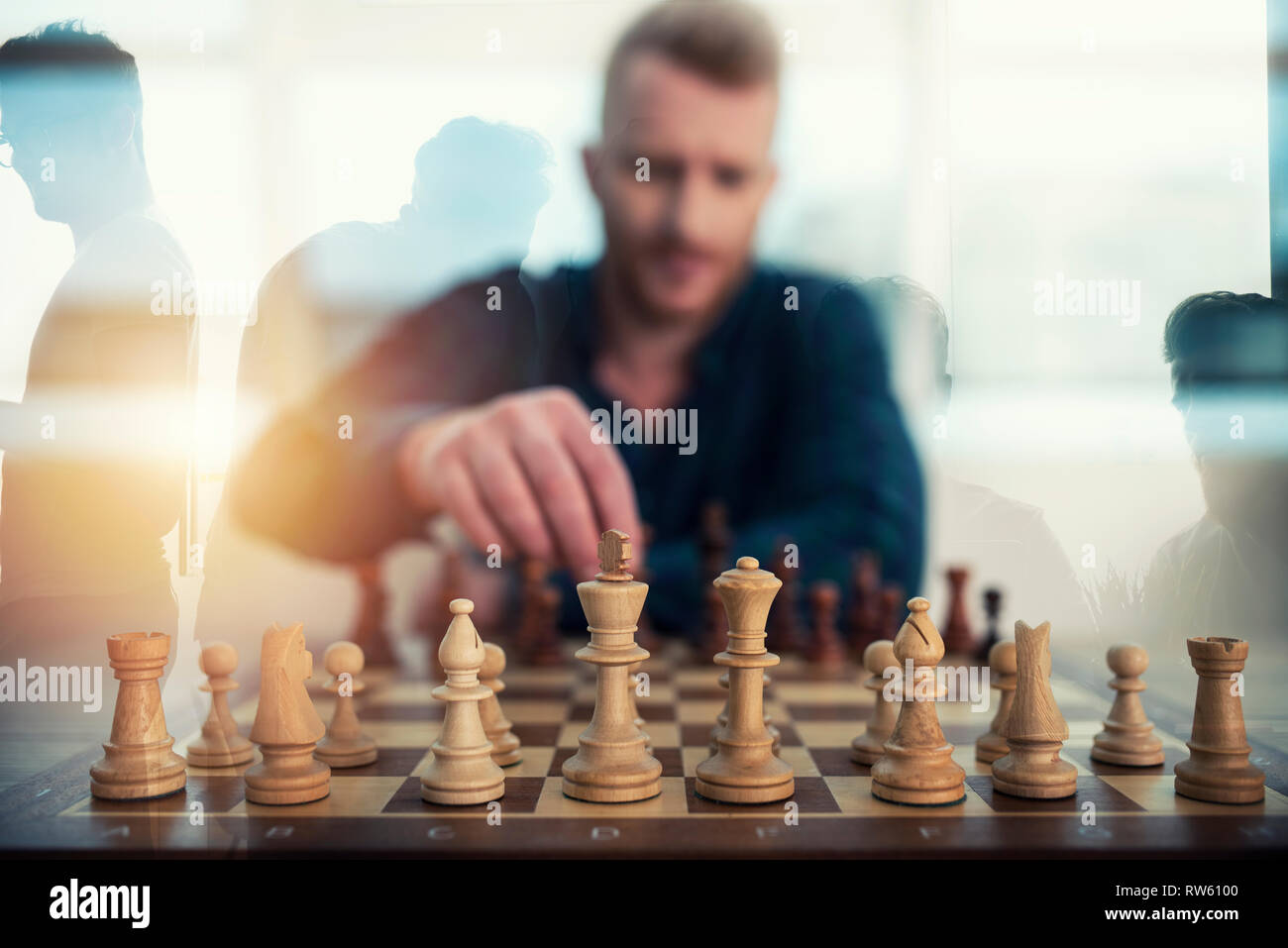 Businessman play with chess game. concept of business strategy and tactic. Double exposure Stock Photo