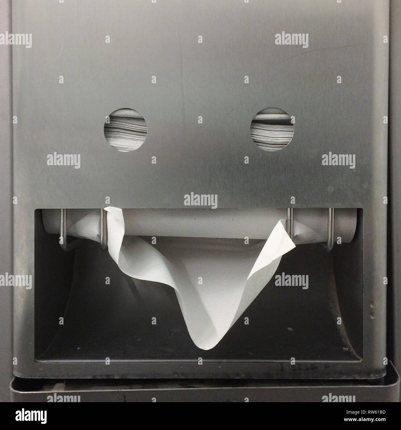 Paper towel holder in the shape of a smiley in a public toilet in the Belvedere Museum in Vienna, Austria. Stock Photo