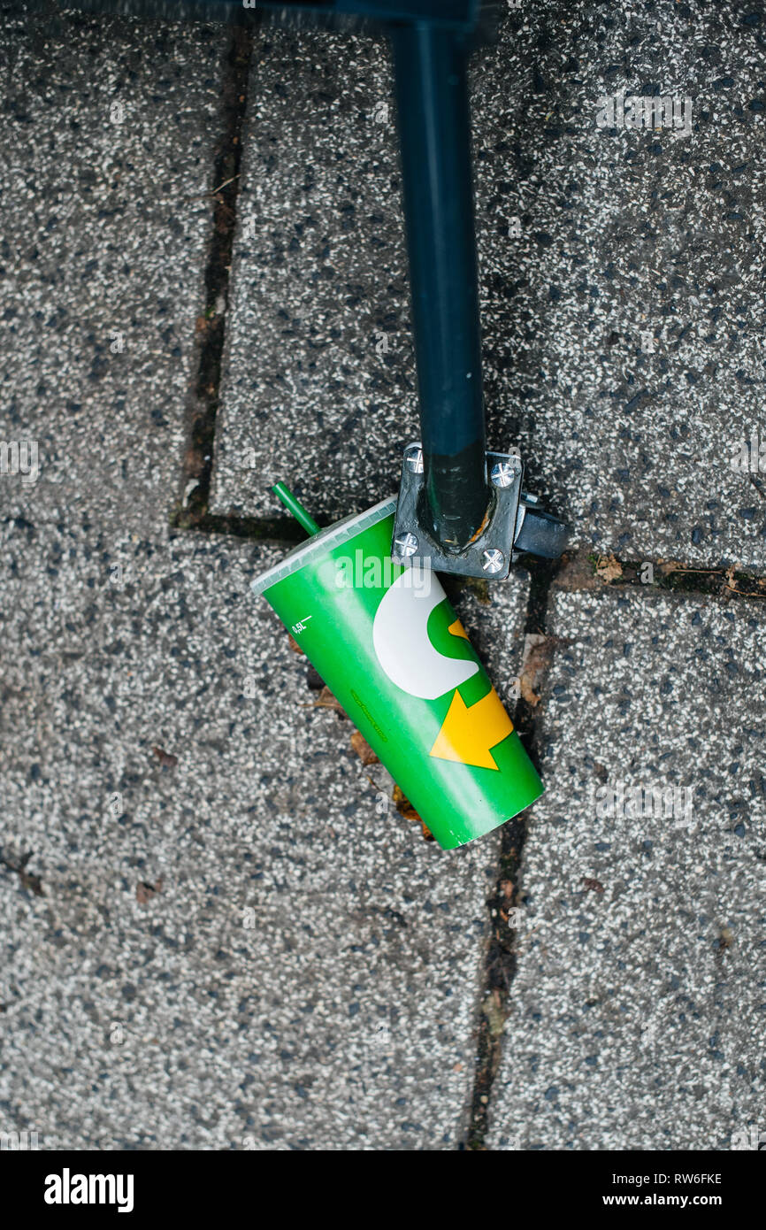 Strasbourg, France - Oct 28, 2018: Subway paper cup on the stone ground in the city - waste on the street Stock Photo