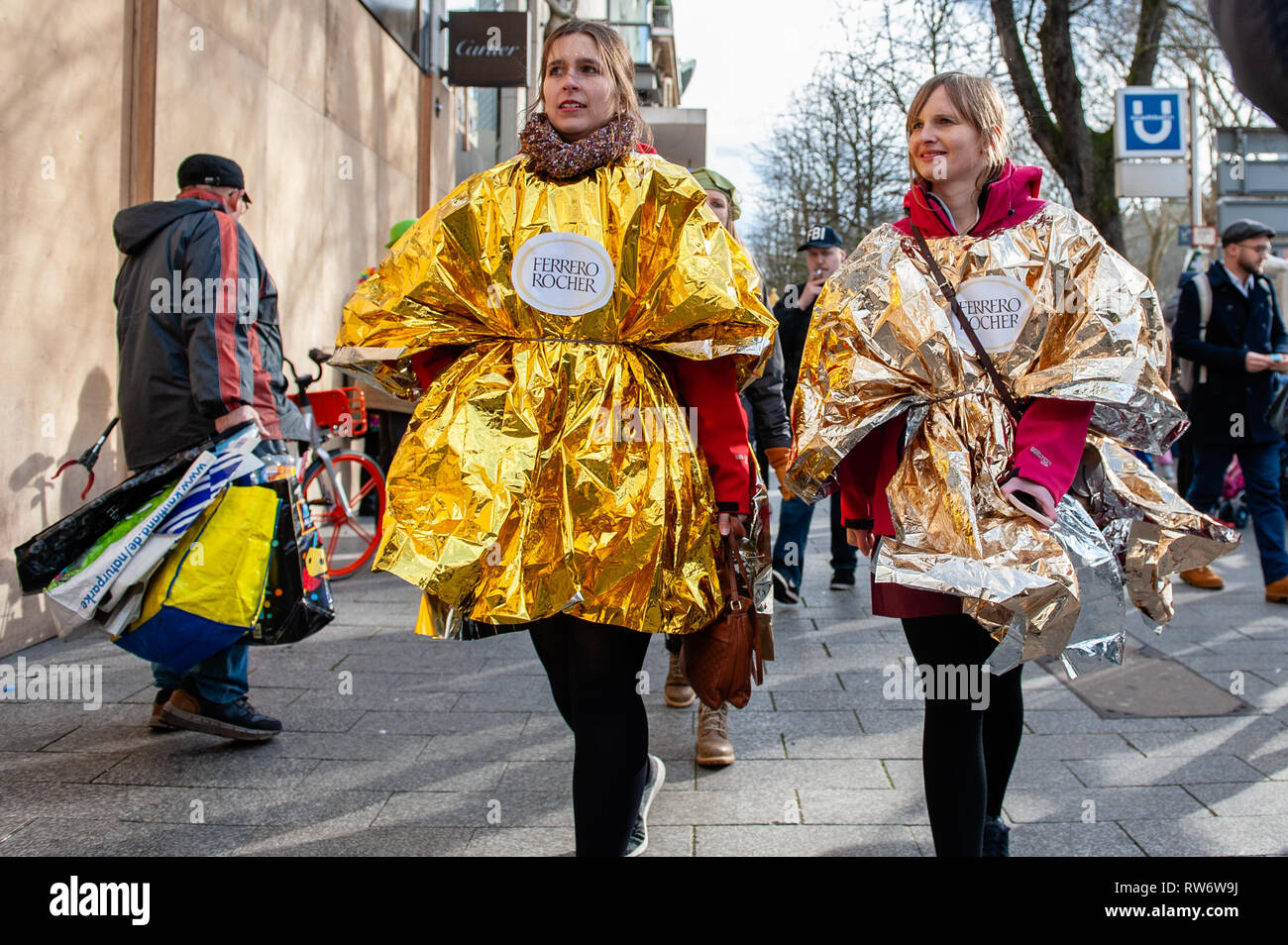 Two women are seen wearing a Ferrero Roche costume during the parade. In  Düsseldorf, the calendar of Carnival events features no fewer than 300  Carnival shows, balls, anniversaries, receptions and costume parties.