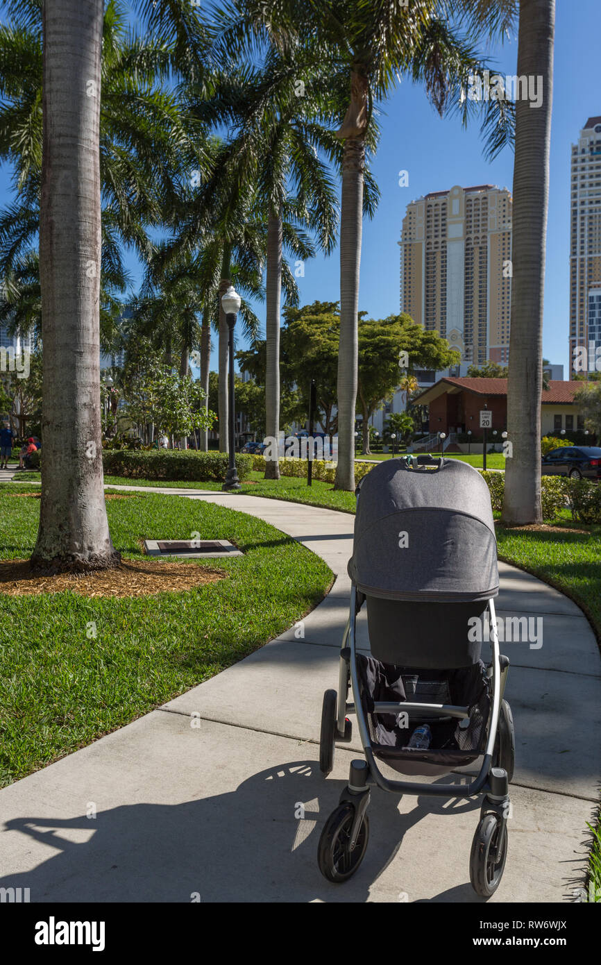Walking with a baby in the stroller Stock Photo