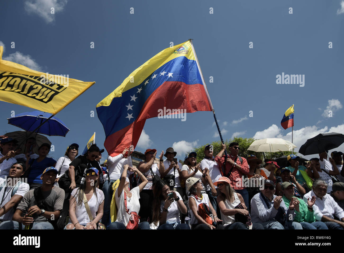 A man seen waving a huge Venezuelan flag during a rally in support of Juan Guaido. Juan Guaido, the Venezuelan opposition leader, where many nations have recognized as the legitimate interim president of Venezuela, greets his supporters during a rally against the government of President Nicolas Maduro in Caracas. Stock Photo