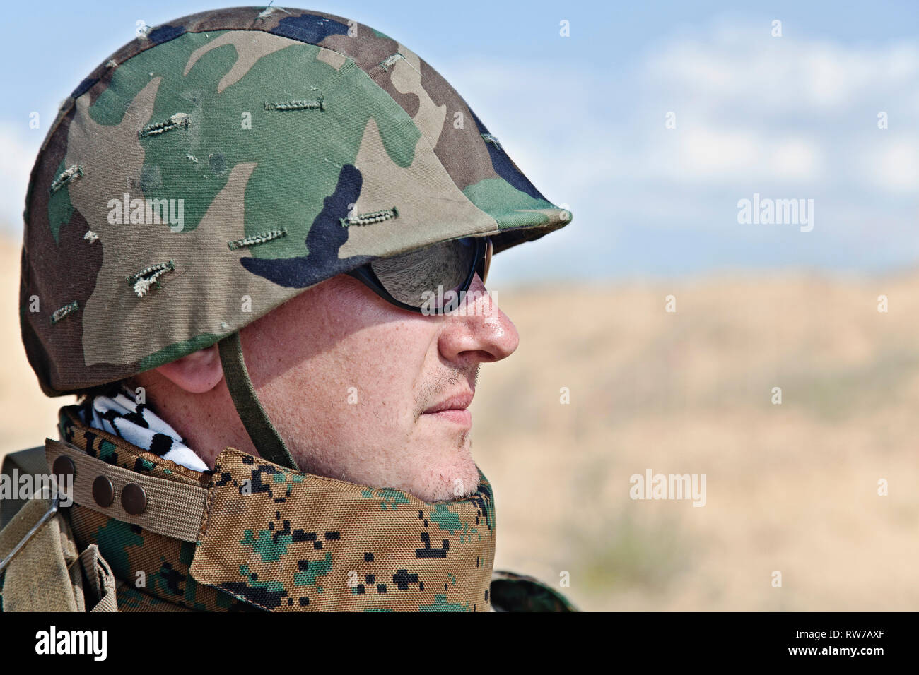 Soldier in military helmet, half-turned to the camera Stock Photo - Alamy