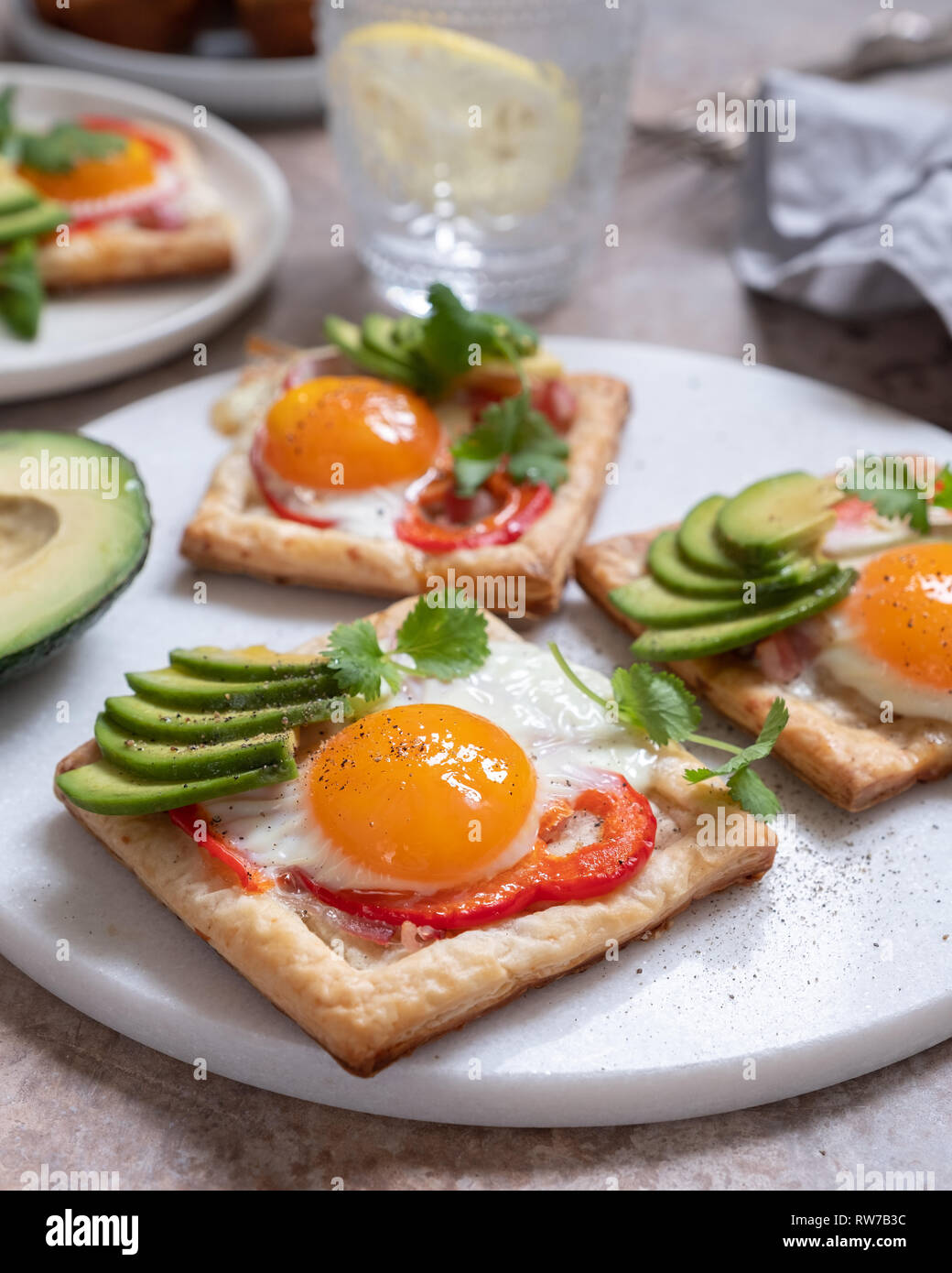 Puff pastry with fried egg, pepper and avocado Stock Photo Alamy