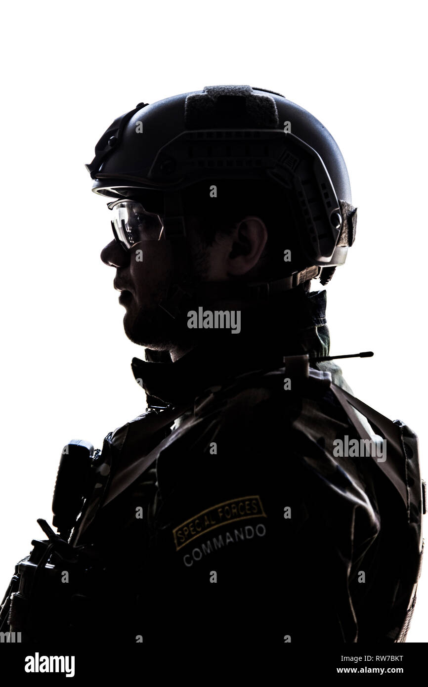 Silhouette of young soldier in military helmet on white background. Stock Photo