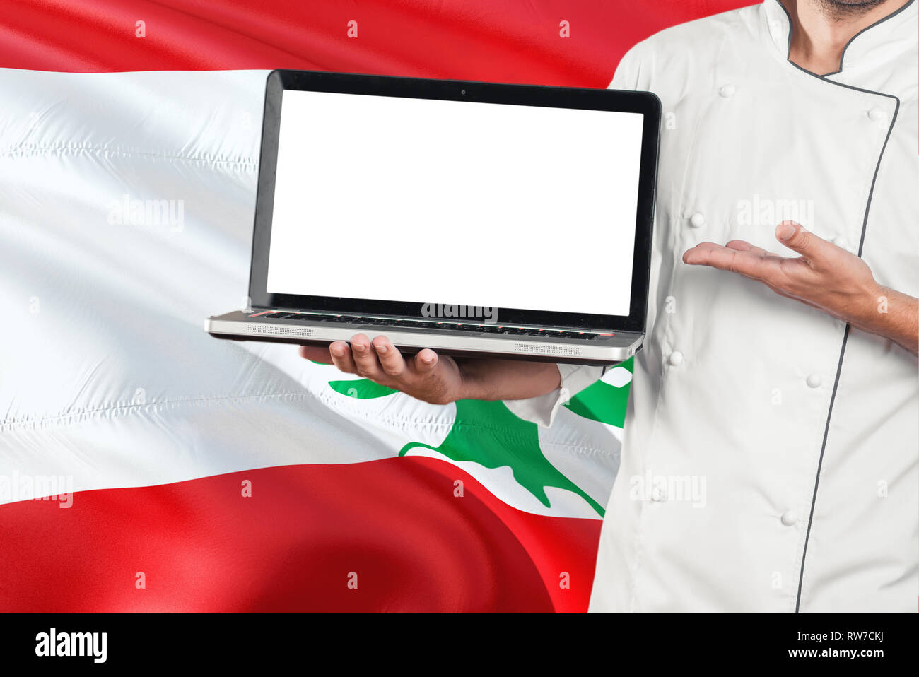 Lebanese Chef holding laptop with blank screen on Lebanon flag