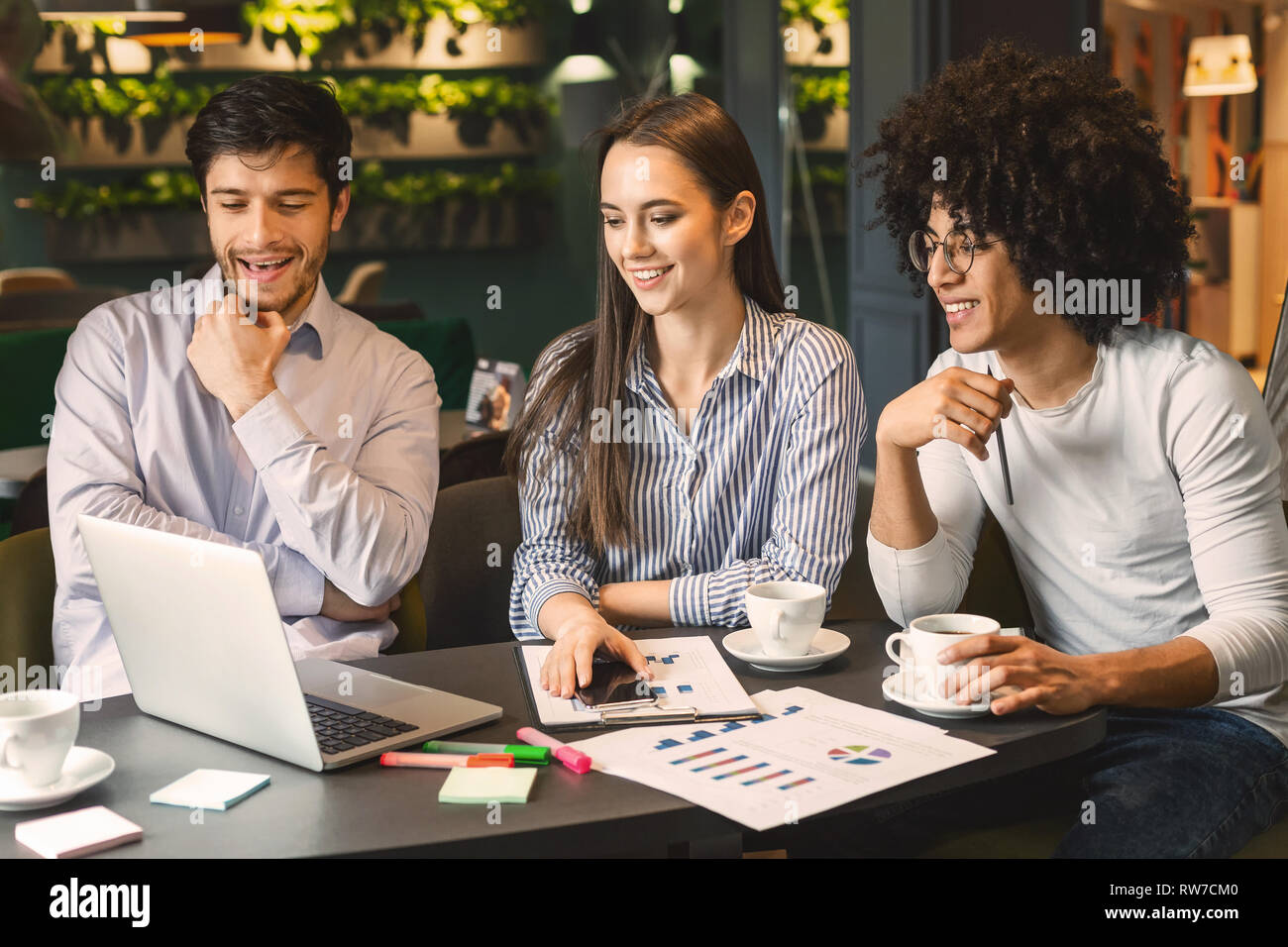 Business partners discussing project during business lunch Stock Photo