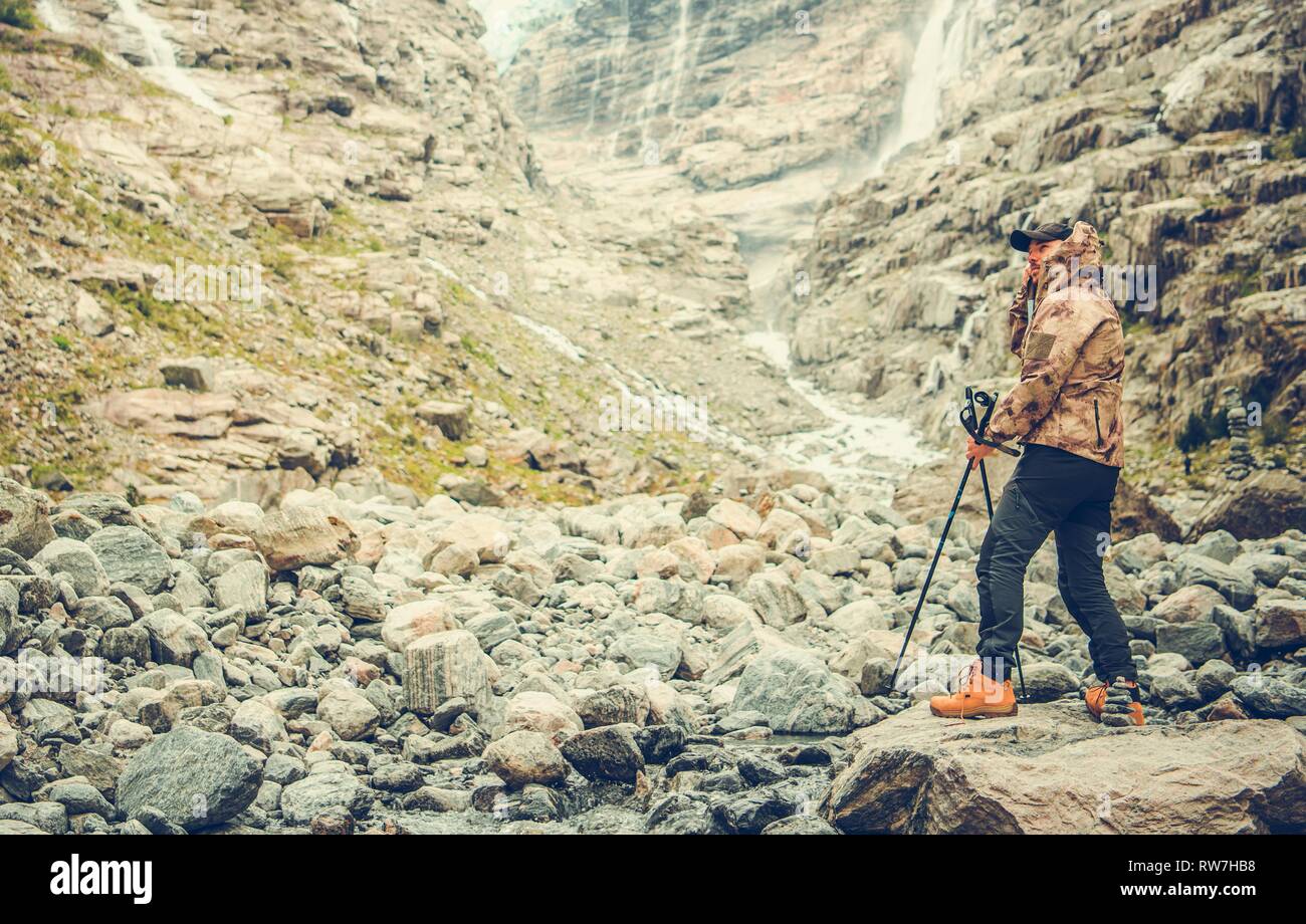 Caucasian Hiker in His 30s Enjoying Raw Alpine Landscape. Active Outdoor Lifestyle. Stock Photo