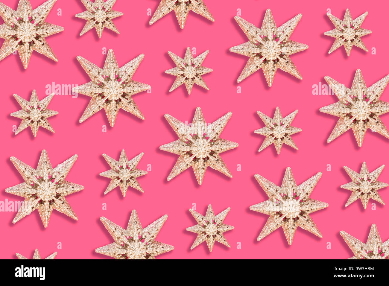 Holiday star pattern on pink background - flat lay Stock Photo
