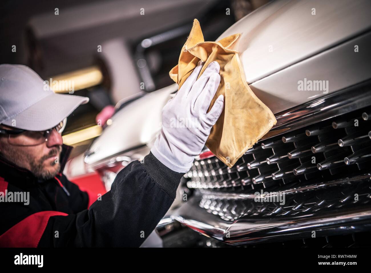 Caucasian Men Cleaning Chrome Grill of Classic Car. Vehicle Maintenance. Stock Photo