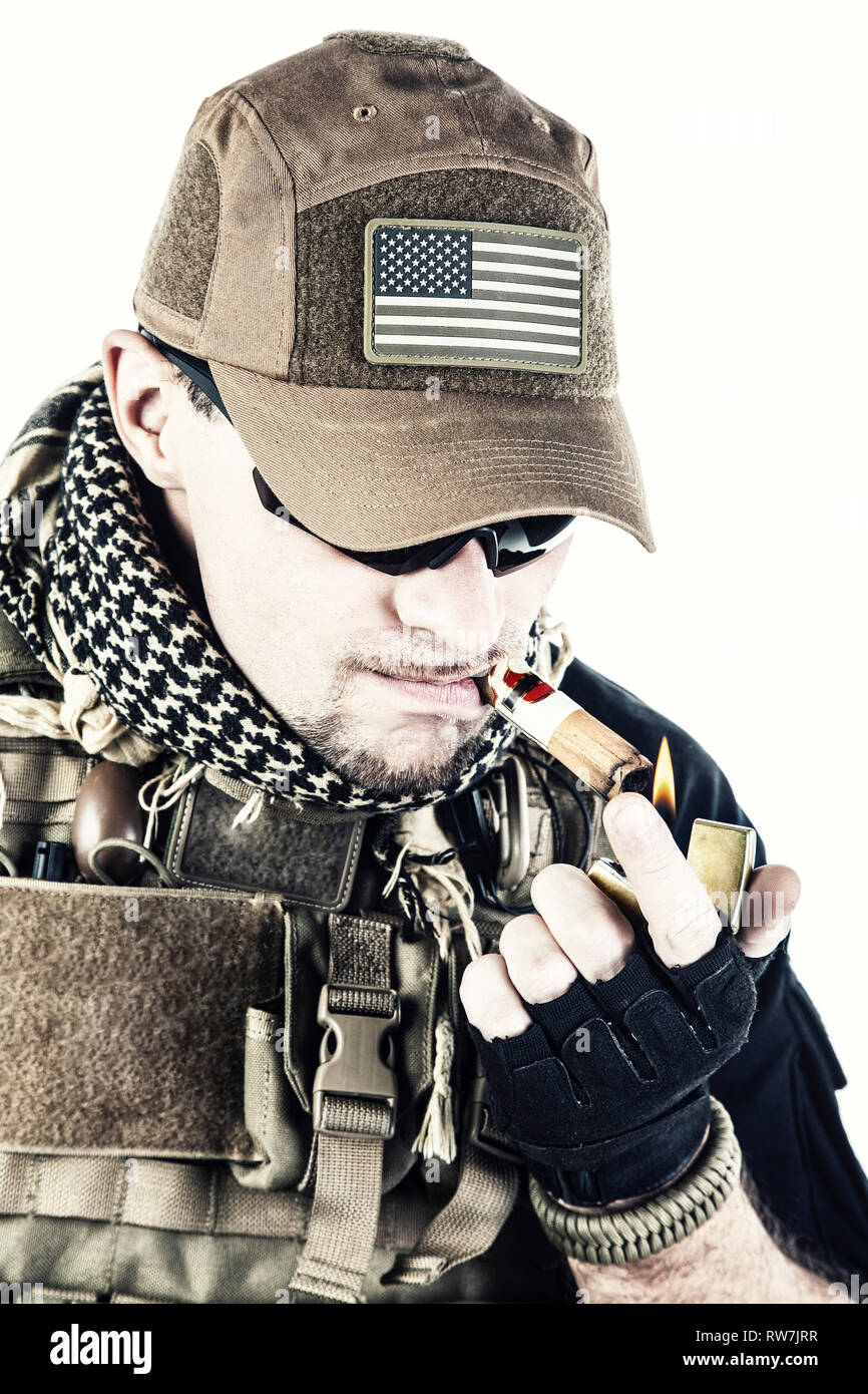 Studio shot of private military contractor PMC smoking a cigar. Stock Photo