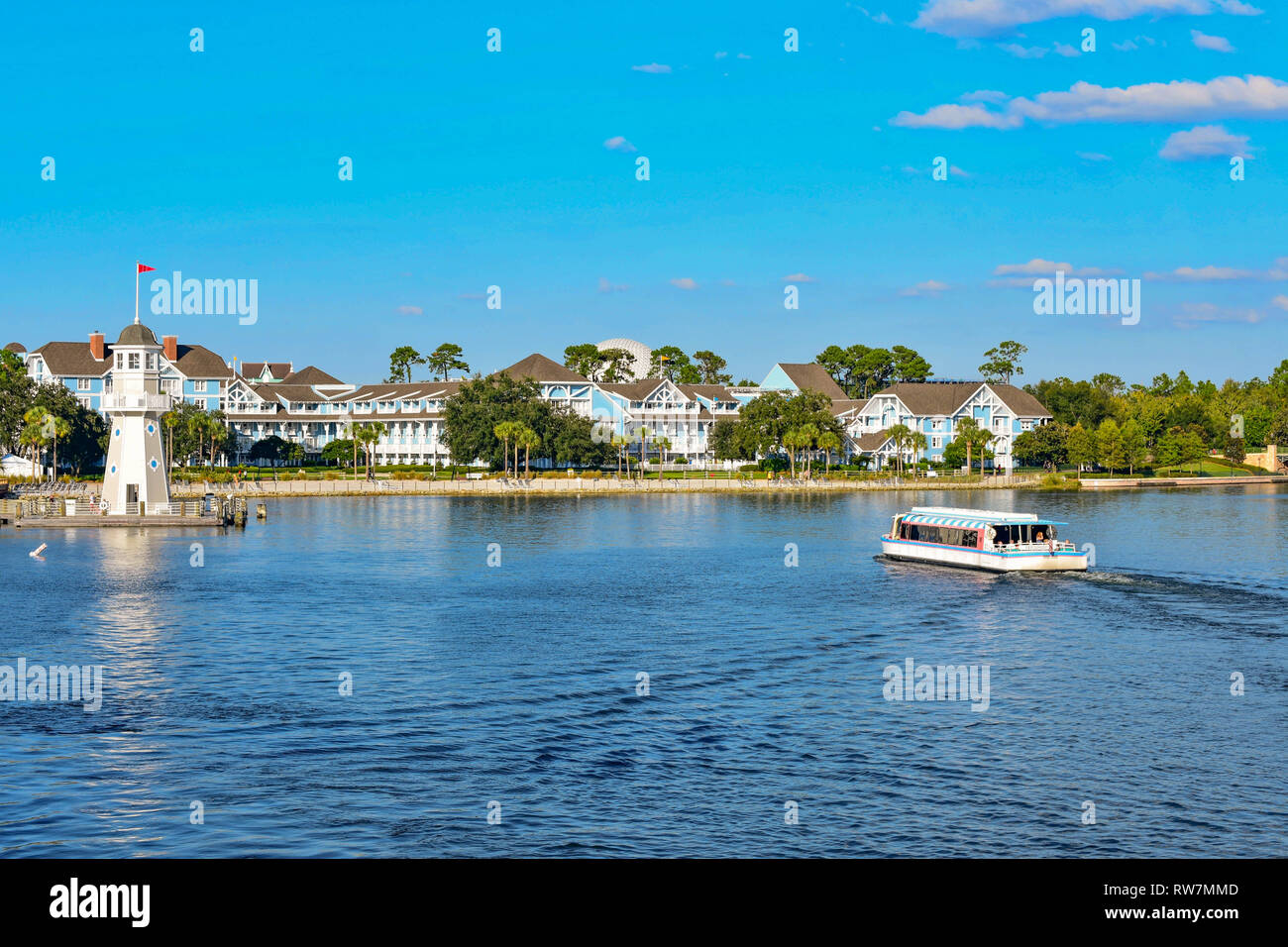 Orlando, Florida. February 09, 2019. Taxi boat sailing on lake, with background of villas and