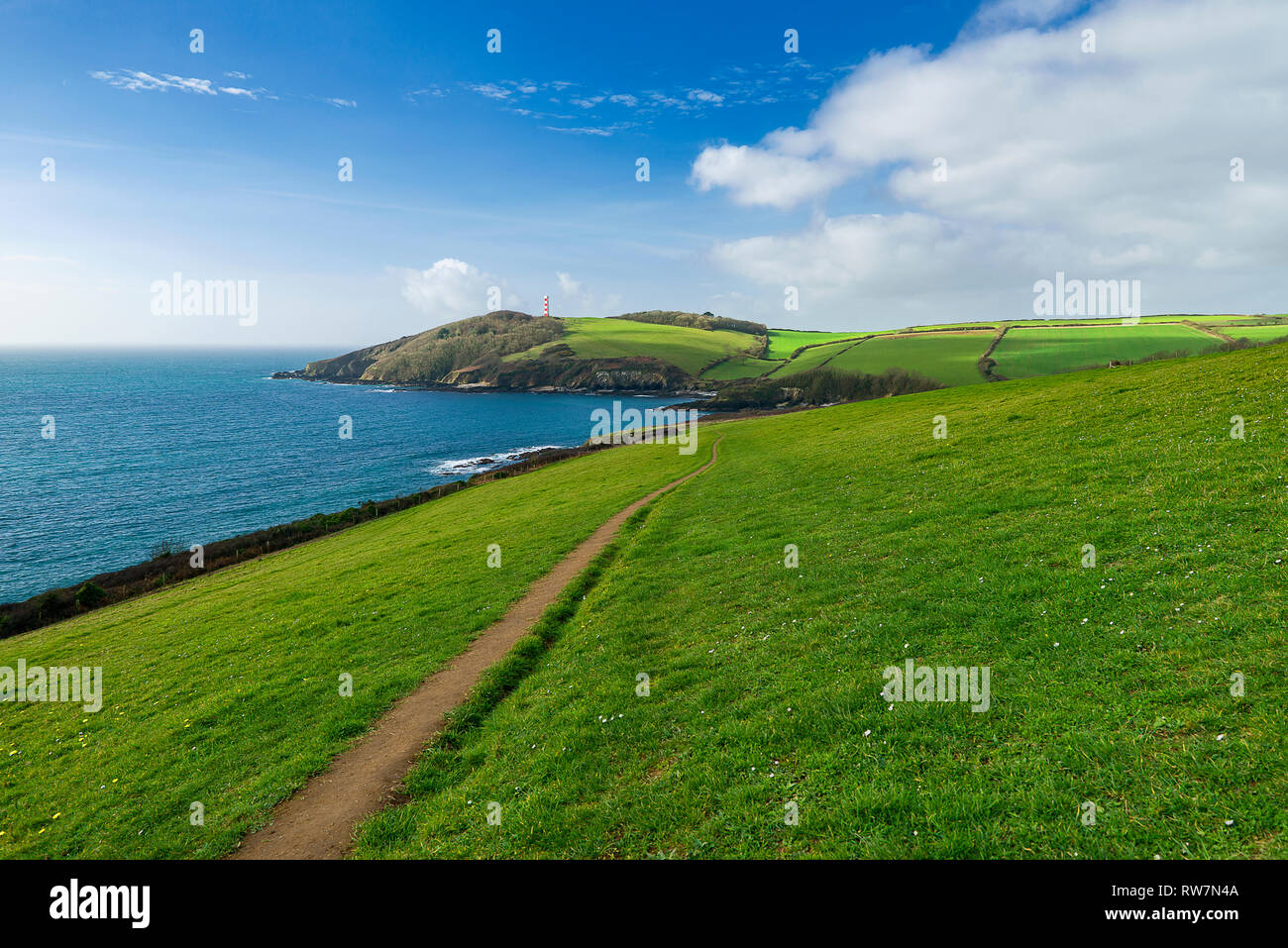 Walking the South West Coast Path from Fowey to Gribbin Head on an unseasonaly warm February day. I'm the person in the photo & allow commercial usage. Stock Photo