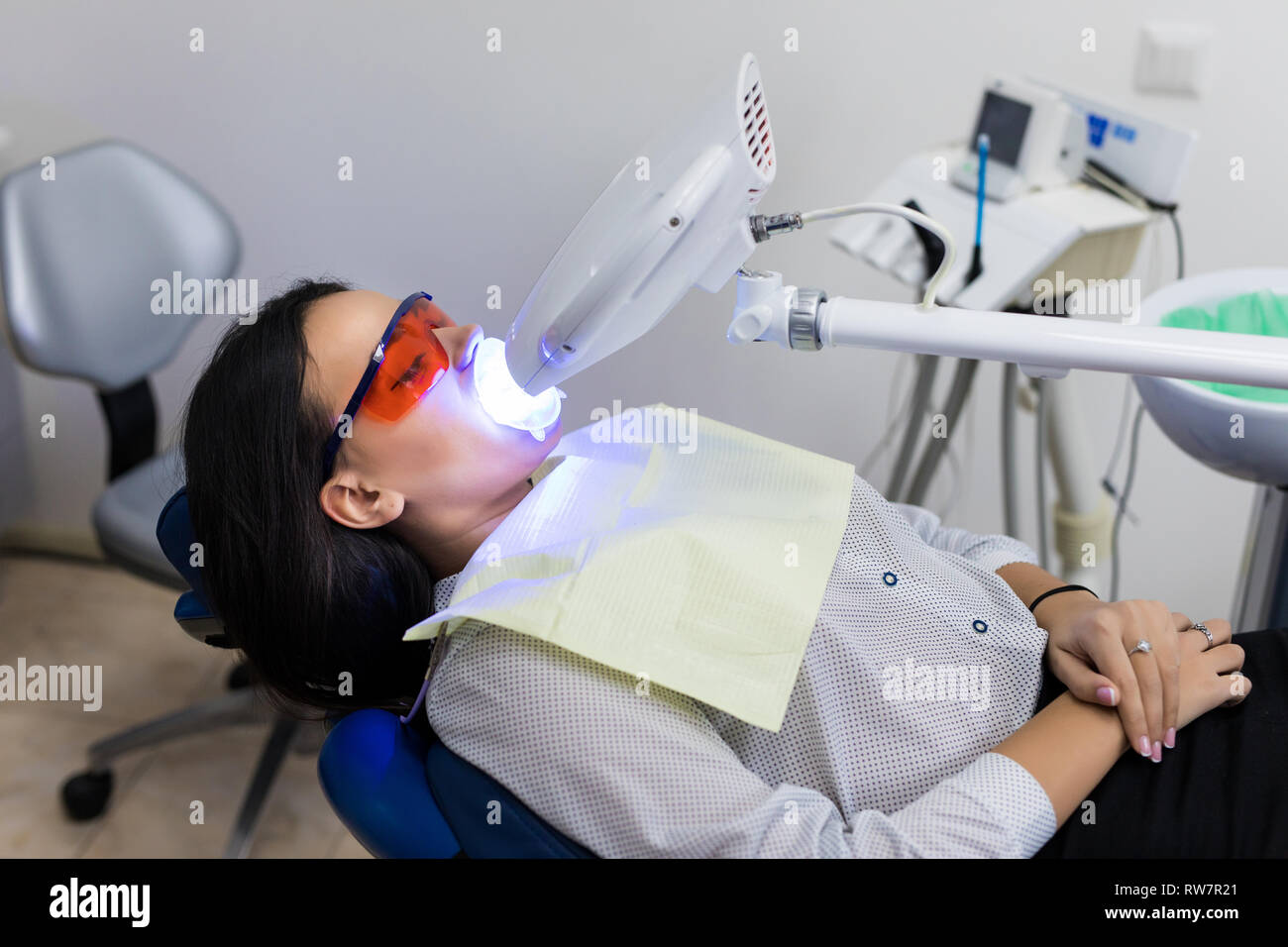 Laser bleaching teeth at dantist room. Teeth whitening for woman. Bleaching of the teeth at dentist clinic Stock Photo