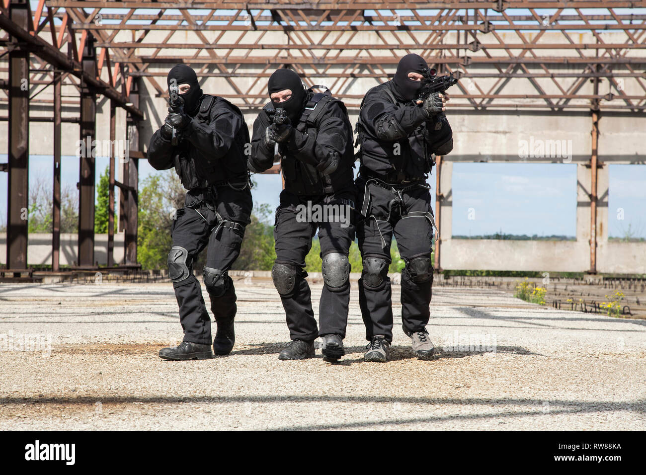 Special forces operators in black uniforms in action Stock Photo Alamy