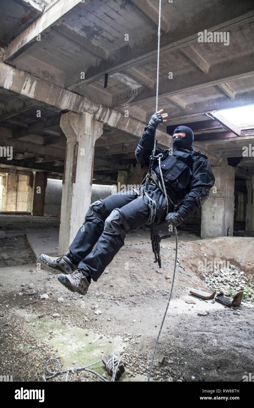 Special forces operator during assault rappelling with weapons Stock Photo  - Alamy