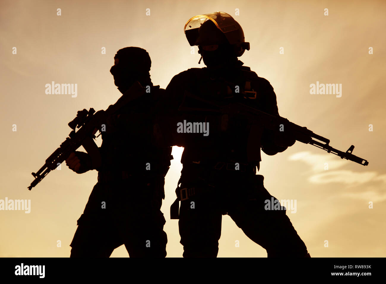 Silhouette of special forces operators with weapons. Stock Photo