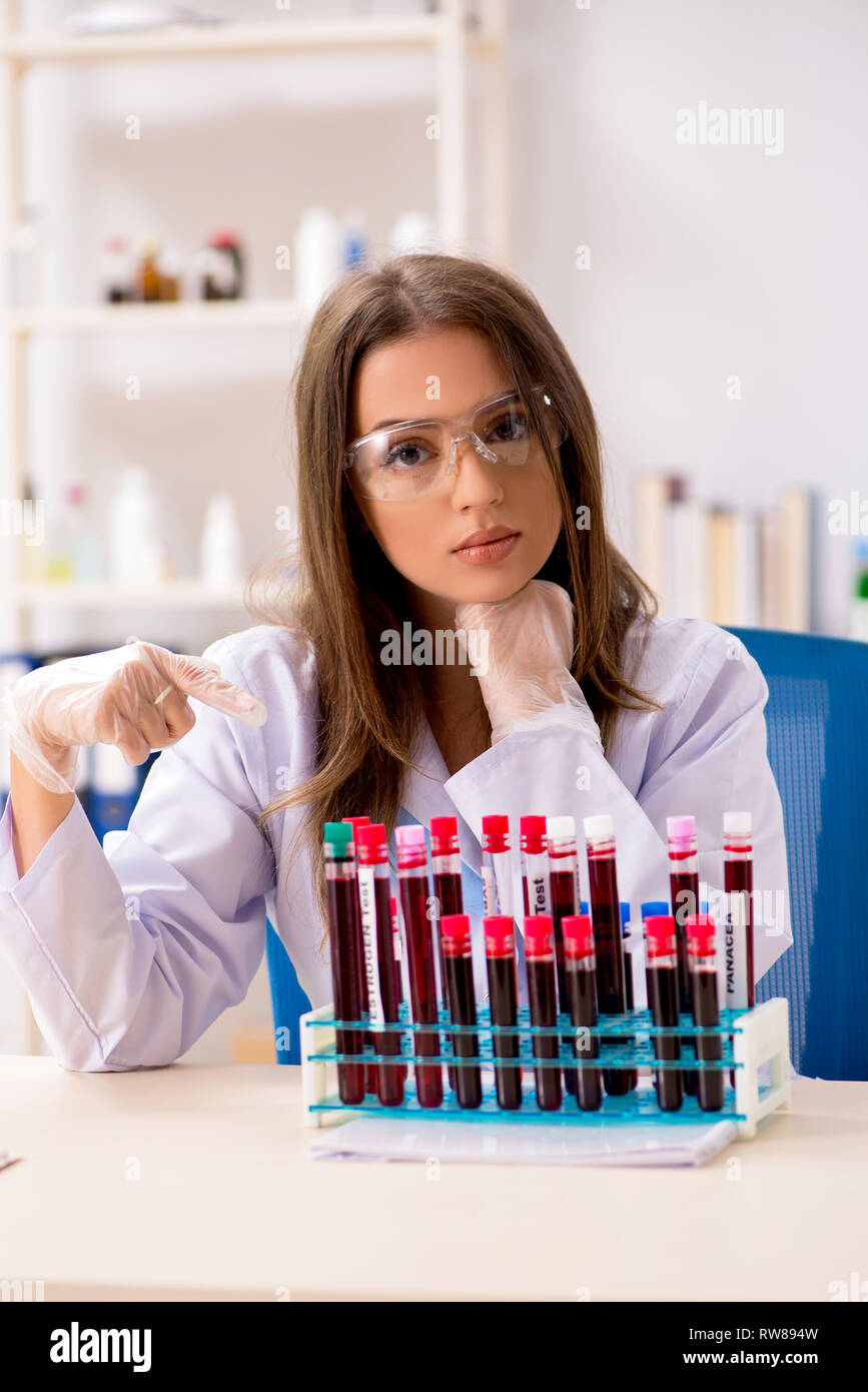 Young beautiful lab assistant testing blood samples Stock Photo Alamy