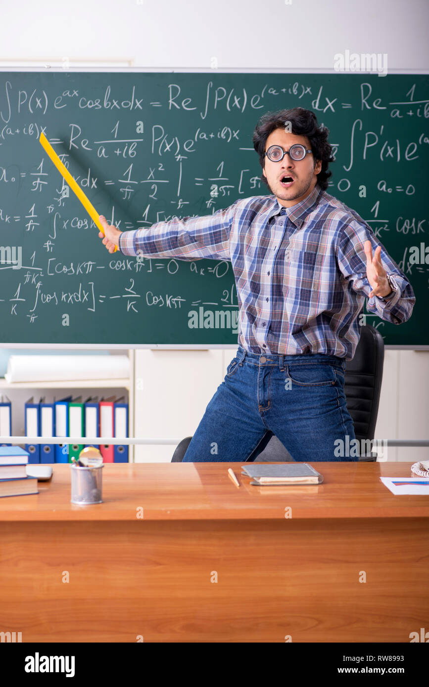 Funny male math teacher in the classroom Stock Photo - Alamy