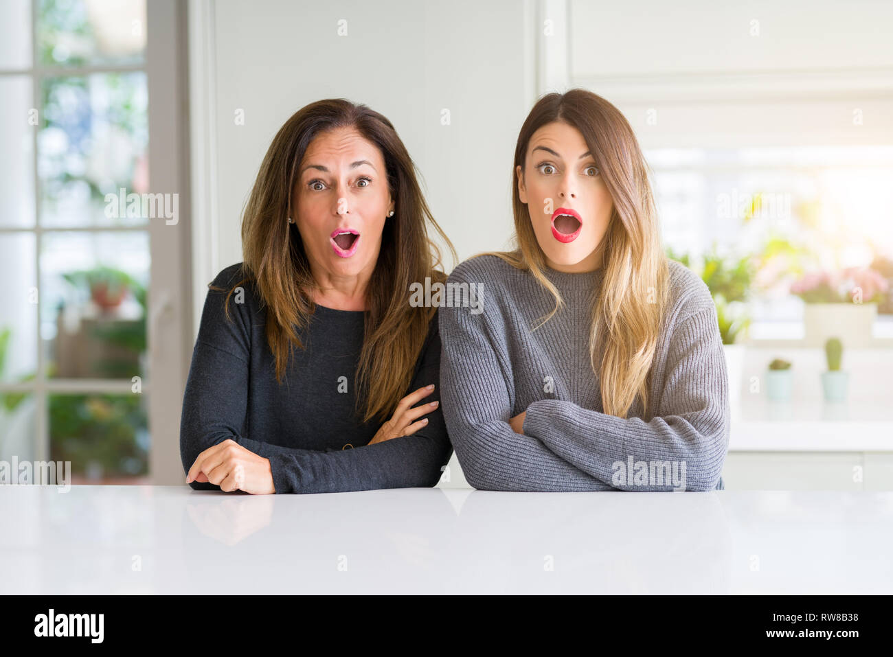 Beautiful family of mother and daughter together at home afraid and(02)