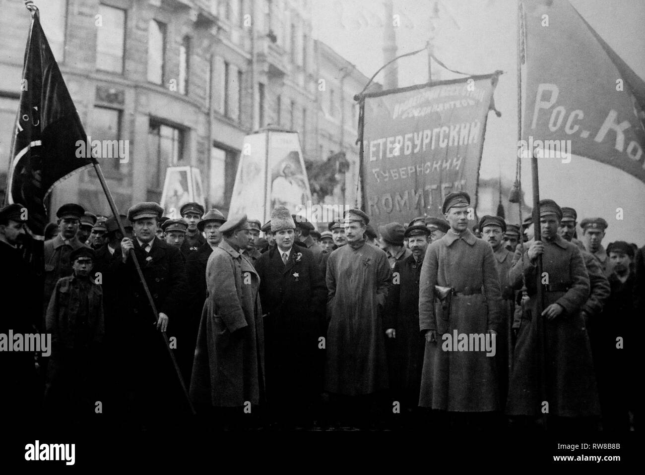 The document shows several Bolshevik leaders in front of a procession for the 1st of May, 1920. In the center, one recognizes Grigori Zinoviev with an Astrakhan. The central banner reads: 'Committee of the Petrograd Province'.  Third on the right from Zinoviev, the man may be Nikolaï Bukharine (1888-1938), member of the Politburo and the Central Committee of the Communist Party, to whom Lenin referred as 'the favorite son of the Party'. Stock Photo