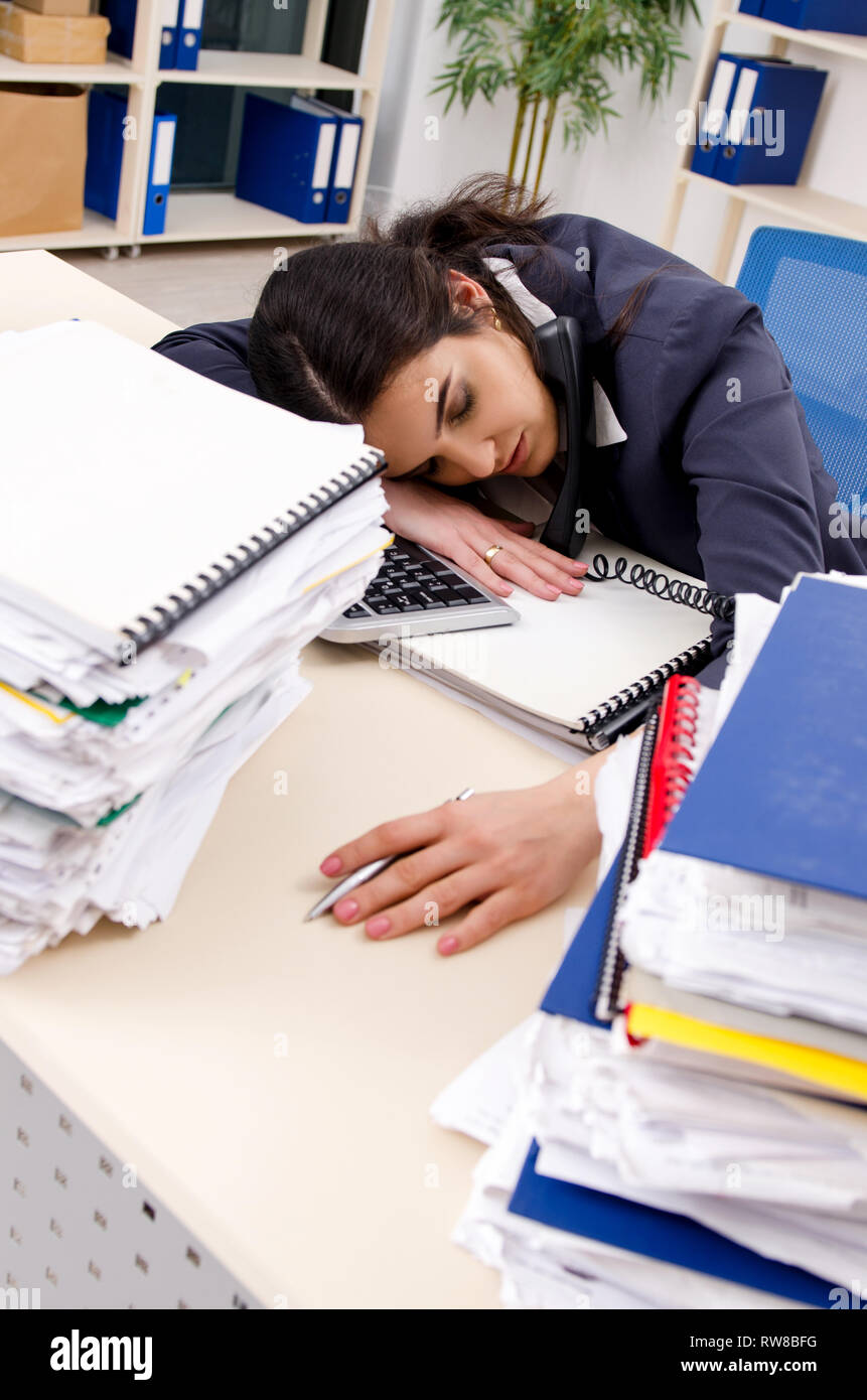 Female employee with too much work in the office Stock Photo - Alamy