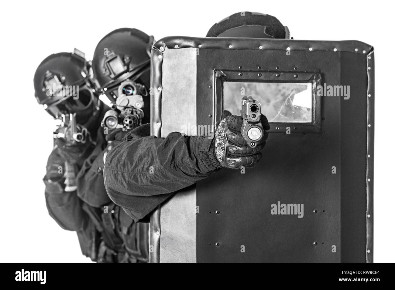 Studio shot of SWAT police special forces hiding behind ballistic ...