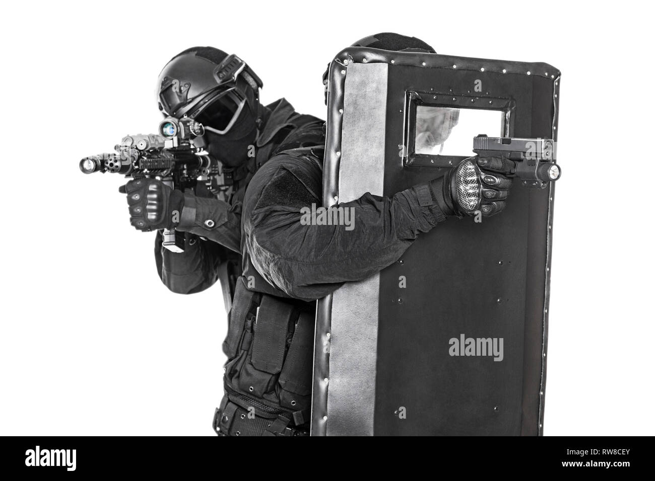 Studio shot of SWAT police special forces hiding behind ballistic