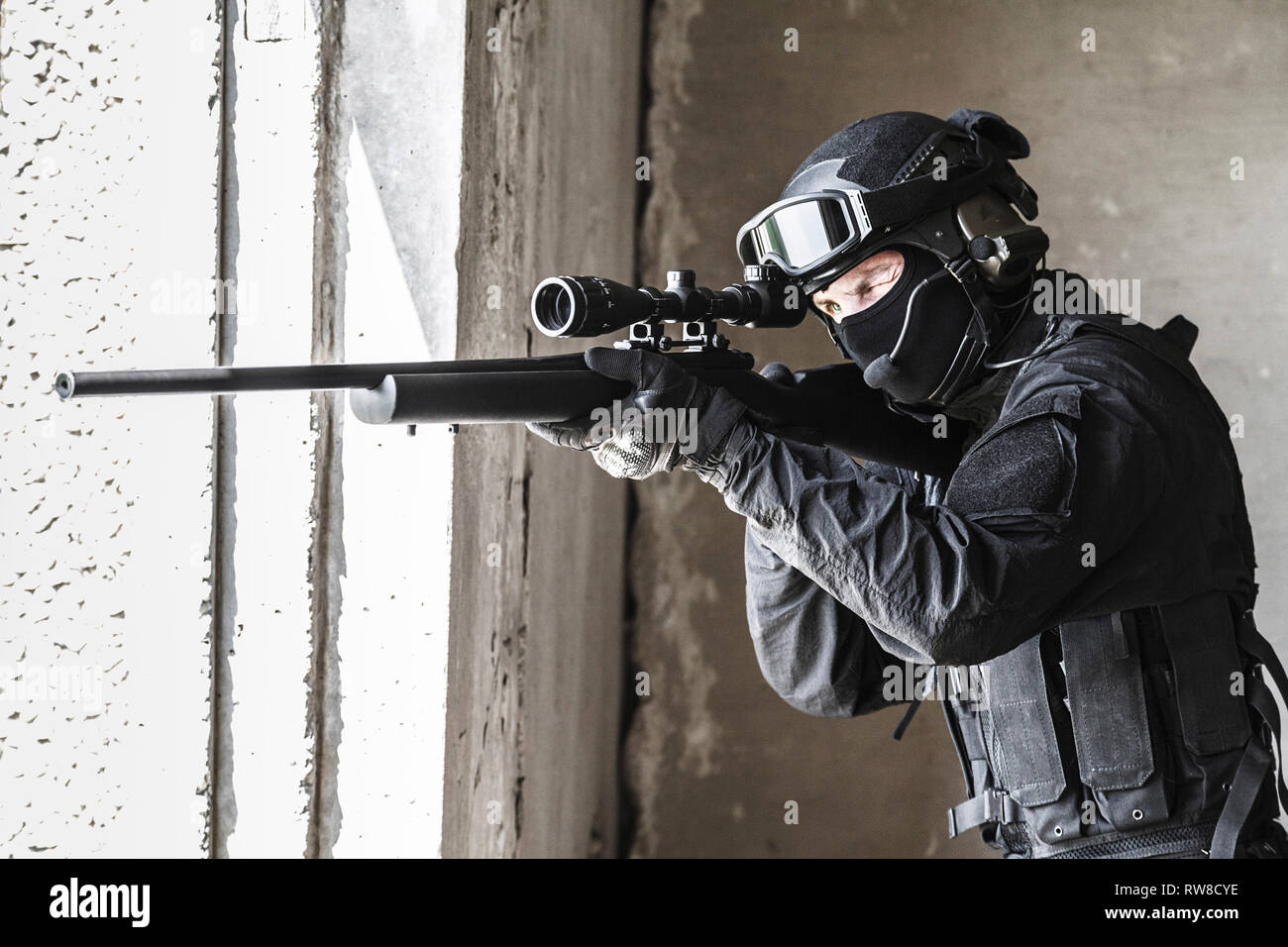 SWAT police operator with sniper rifle aiming from the window Stock Photo -  Alamy