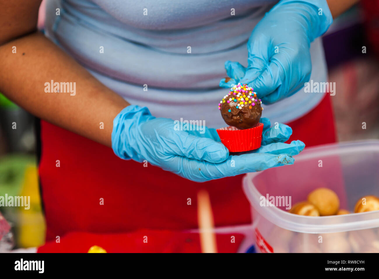 Fruits covered with chocolate and balls of candies Stock Photo Alamy