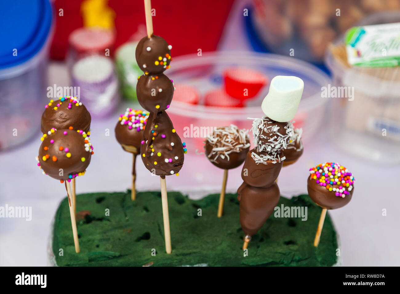 Fruits covered with chocolate and balls of candies Stock Photo Alamy