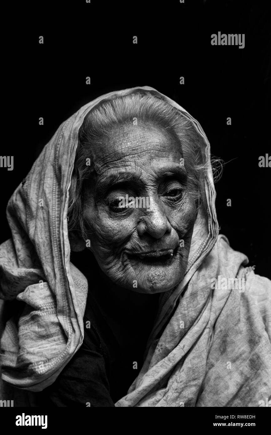 This photo was taken in slum. She is 100+ years old women live her combined  family. Stock Photo