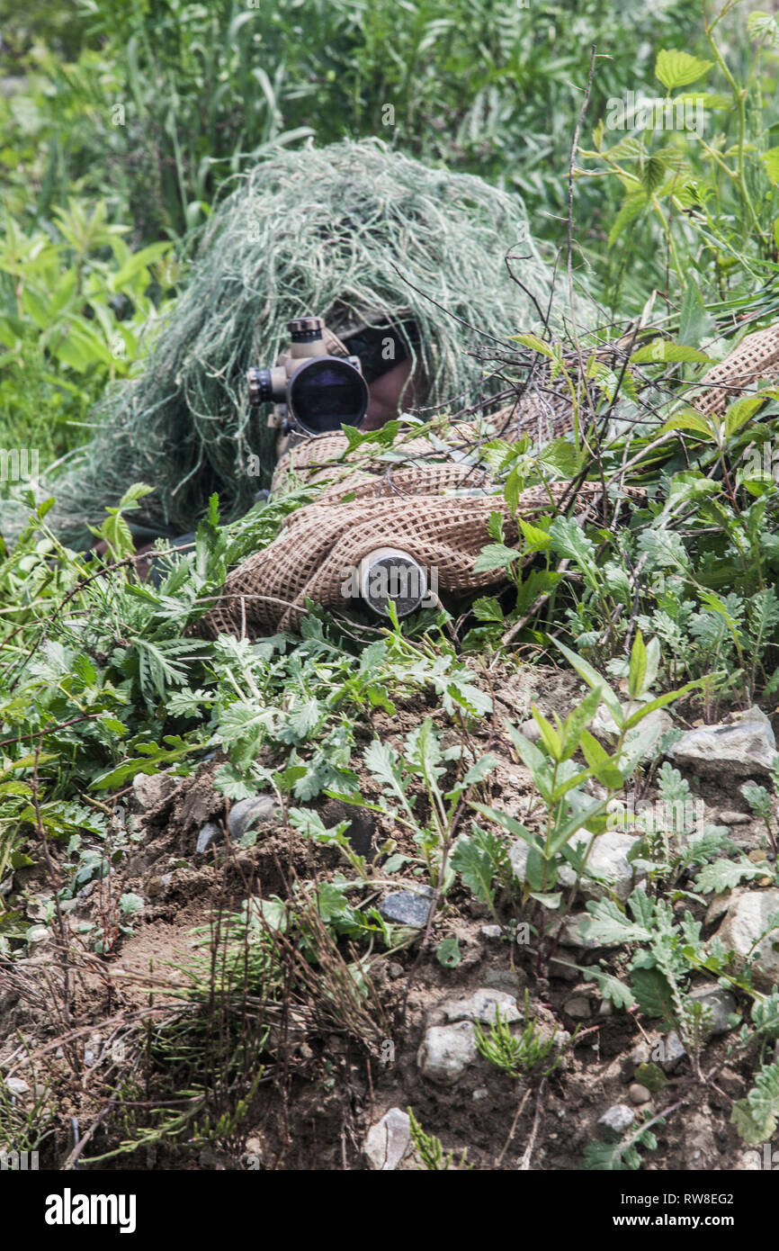 Navy Seal sniper with rifle in action. Stock Photo