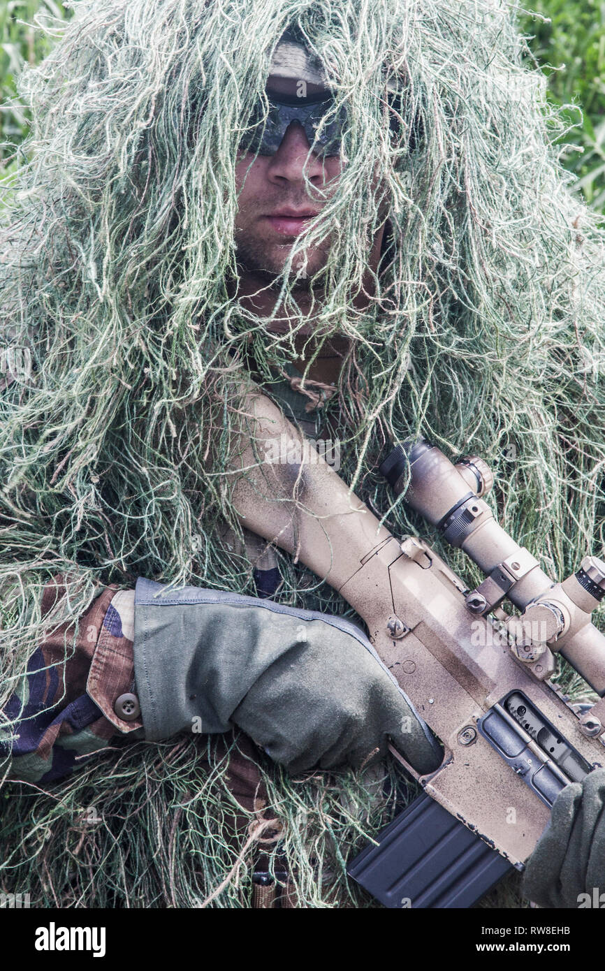 Navy Seal sniper with rifle in action. Stock Photo