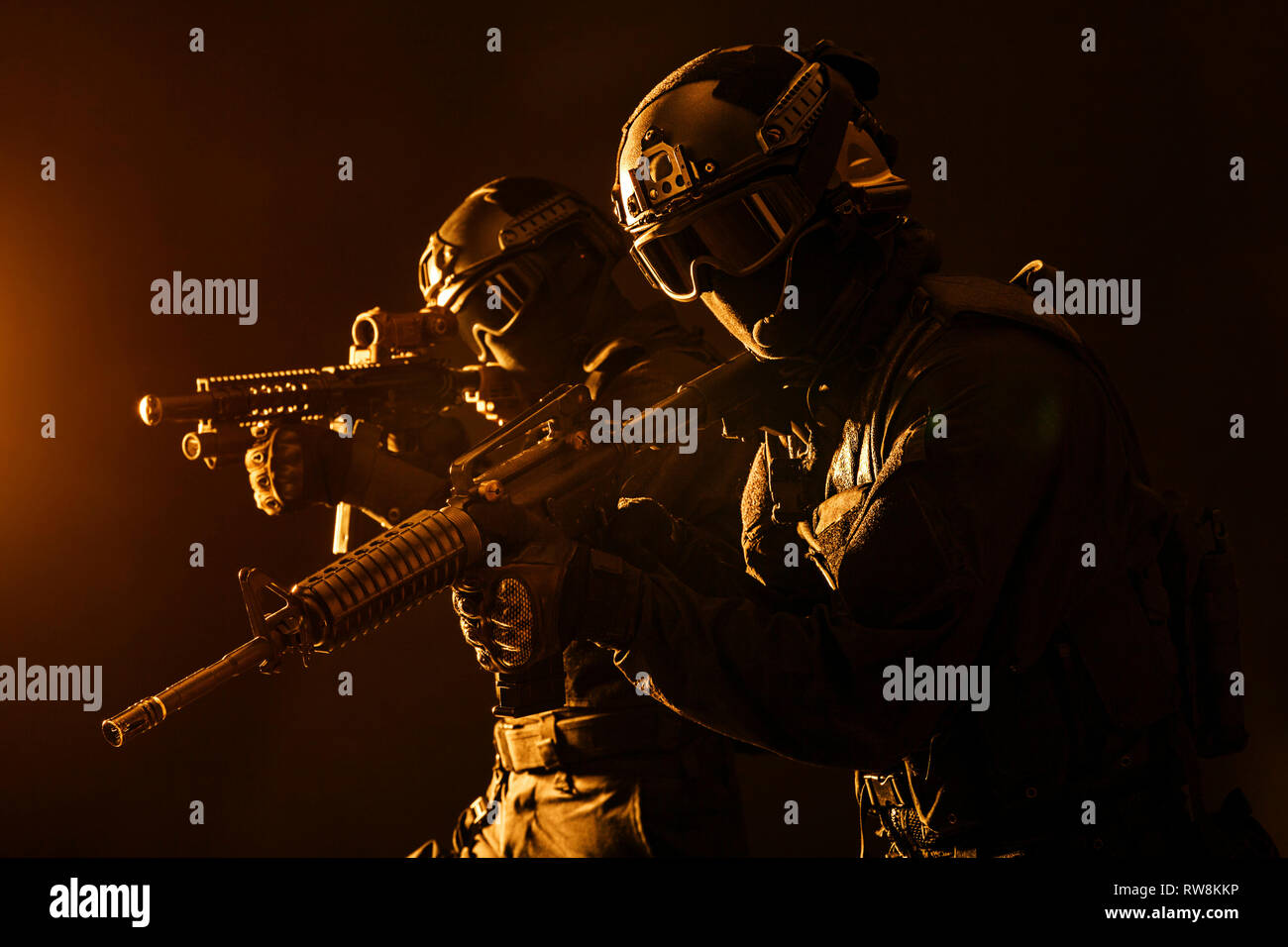 Spec ops police officers SWAT in black uniform and face mask, studio ...