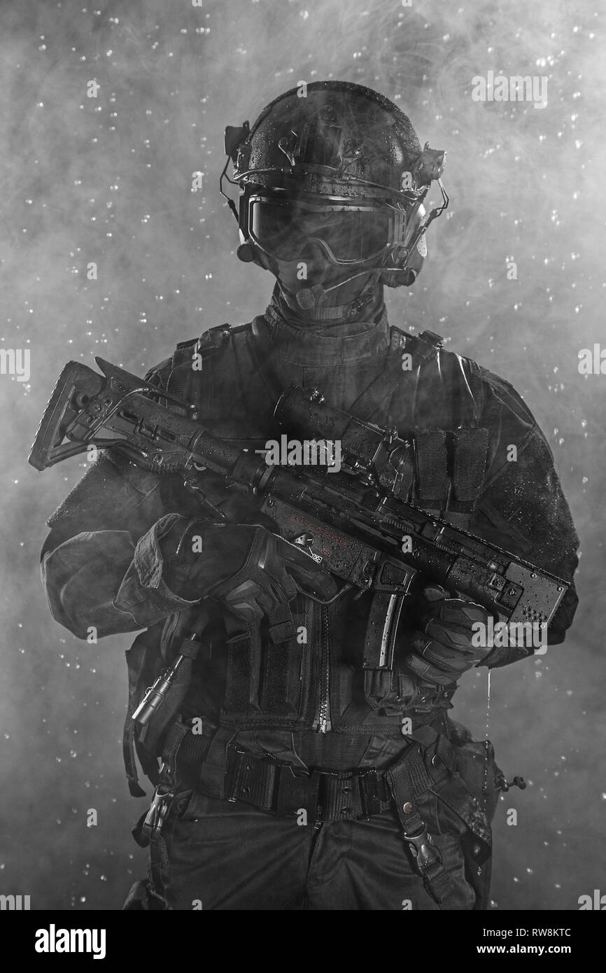 Police officer SWAT in black uniform in the smoke Stock Photo - Alamy
