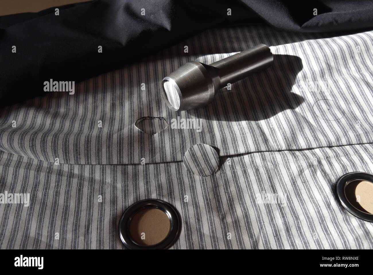 Curtain eyelets grommet and hole cutting tools used to add eyelets to