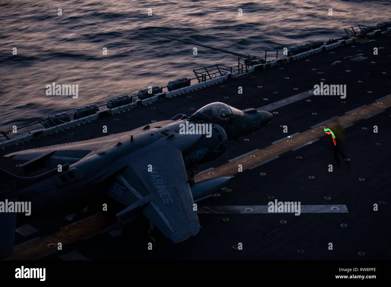 An AV-8B Harrier with the 22nd Marine Expeditionary Unit prepares to take off from the flight deck aboard the Wasp-class amphibious assault ship USS Kearsarge (LHD-3). The Harriers, with Marine Medium Tiltrotor Squadron 264 (Reinforced), carry out daily routine flights in order to maintain operational readiness. Marines and Sailors with the 22nd MEU and Kearsarge Amphibious Ready Group are currently deployed to the U.S. 5th Fleet area of operations in support of naval operations to ensure maritime stability and security in the Central region, connecting the Mediterranean and the Pacific throug Stock Photo