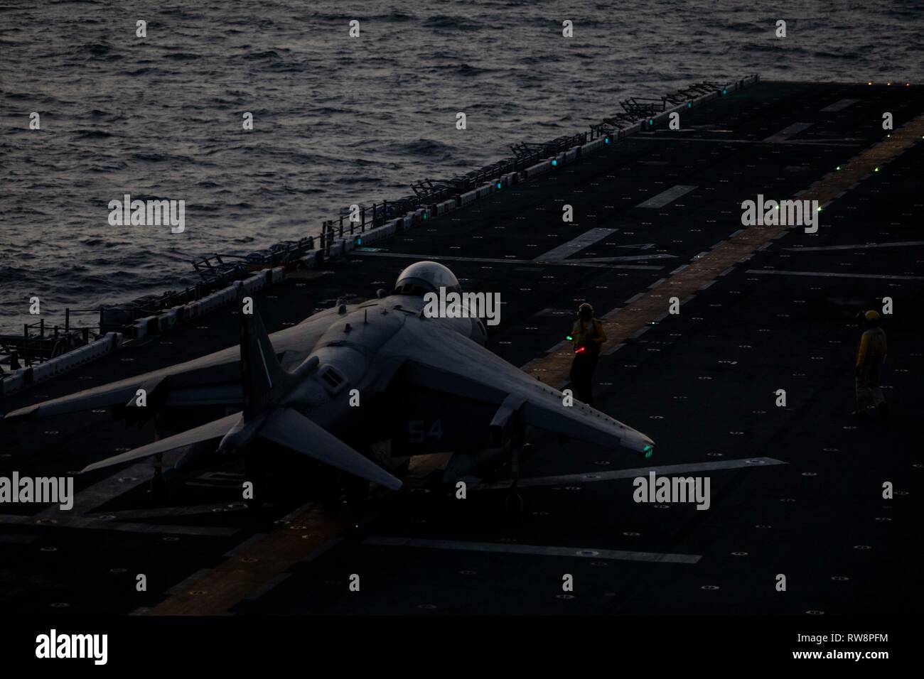 An AV-8B Harrier with the 22nd Marine Expeditionary Unit prepares to take off from the flight deck aboard the Wasp-class amphibious assault ship USS Kearsarge (LHD-3). The Harriers, with Marine Medium Tiltrotor Squadron 264 (Reinforced), carry out daily routine flights in order to maintain operational readiness. Marines and Sailors with the 22nd MEU and Kearsarge Amphibious Ready Group are currently deployed to the U.S. 5th Fleet area of operations in support of naval operations to ensure maritime stability and security in the Central region, connecting the Mediterranean and the Pacific throug Stock Photo