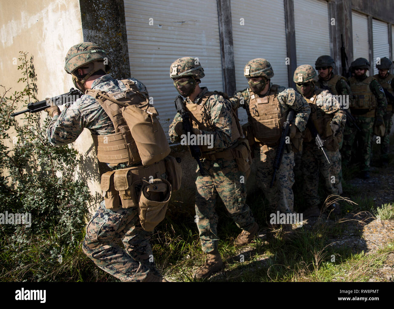 U.S. Marines with Special Purpose Marine Air-Ground Task Force-Crisis Response-Africa 19.1, Marine Forces Europe and Africa, prepare to clear a building during a training event with Portuguese marines in Troia, Portugal, Feb. 25, 2019. SPMAGTF-CR-AF is a rotational force deployed to conduct crisis-response and theater-security operations in Europe and Africa. (U.S. Marine Corps photo by Sgt. Katelyn Hunter) Stock Photo