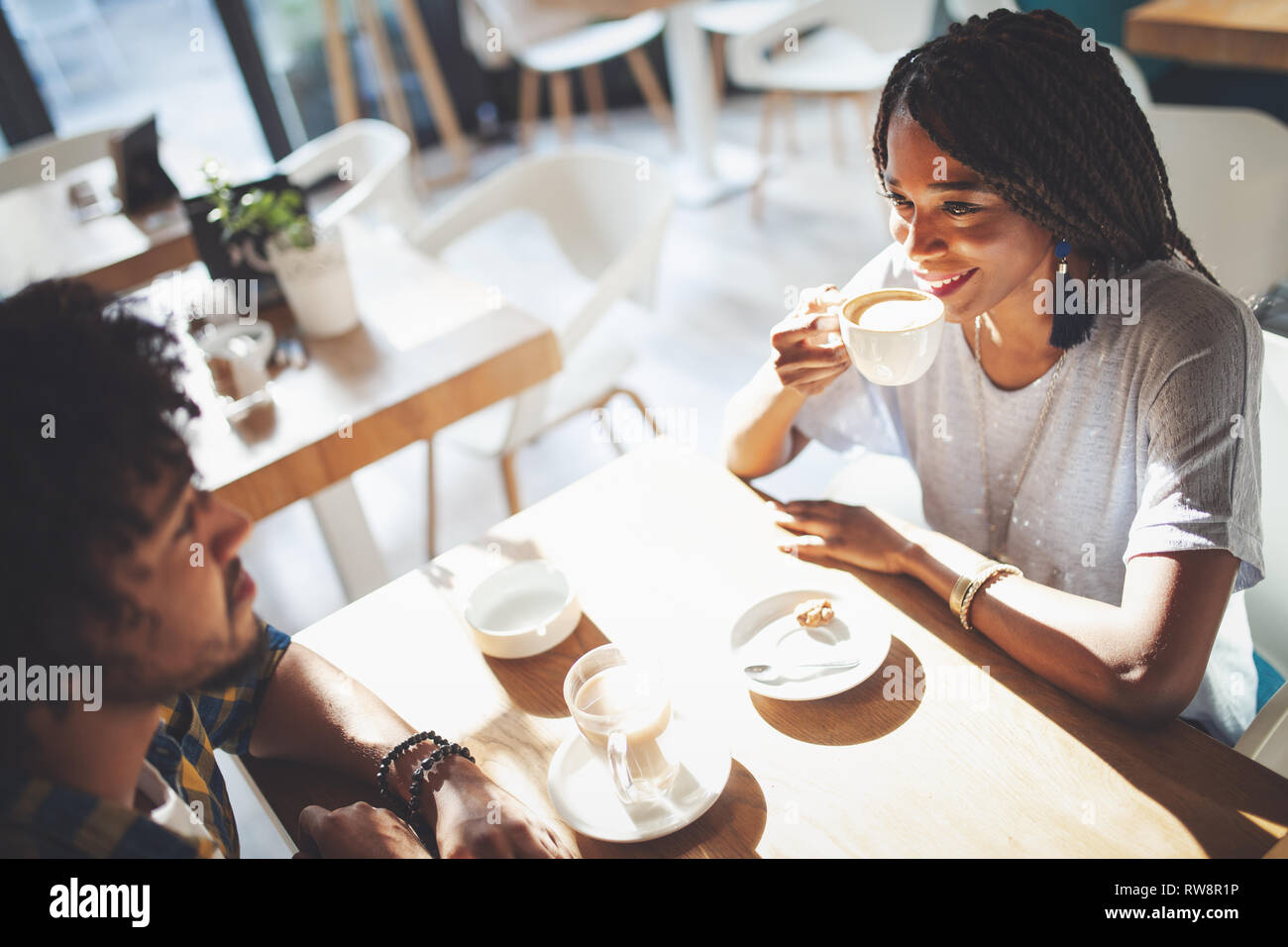 Laughing young couple in cafe, having a great time together Stock Photo